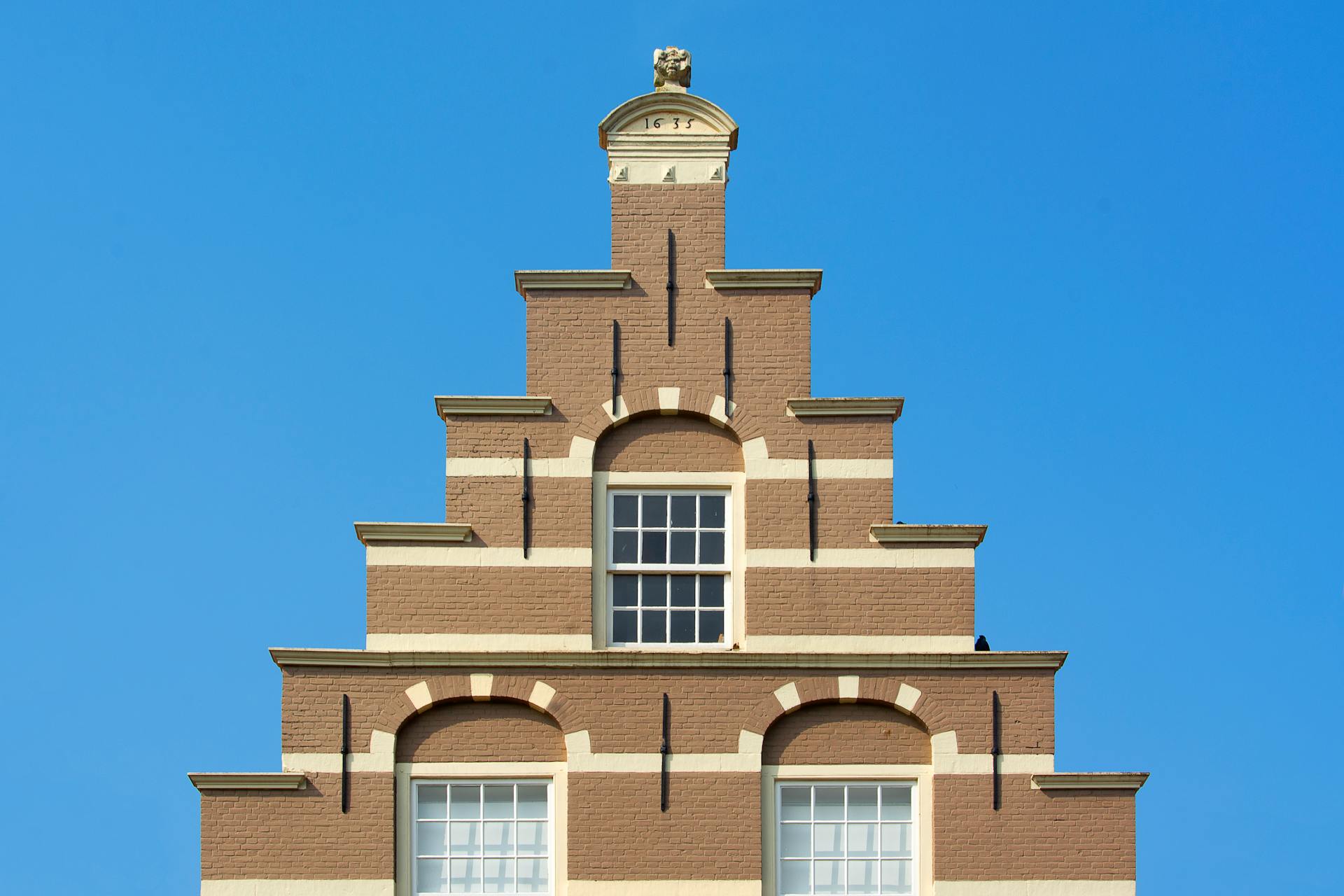 Historic Stepped Gable House Facade against Blue Sky