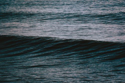Free Peaceful twilight ocean wave captured with rich textures and deep tones. Stock Photo