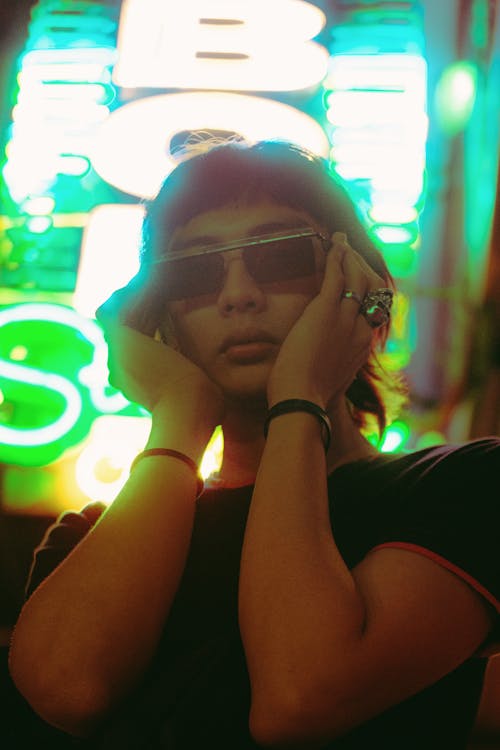 Woman Holding Sunglasses Wearing Black T-shirt