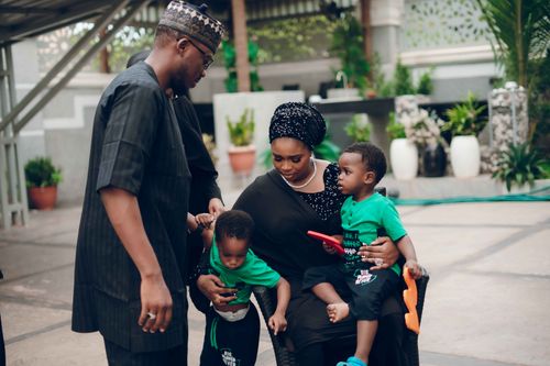 Free A family enjoying time together outdoors, with parents holding their young children. Stock Photo