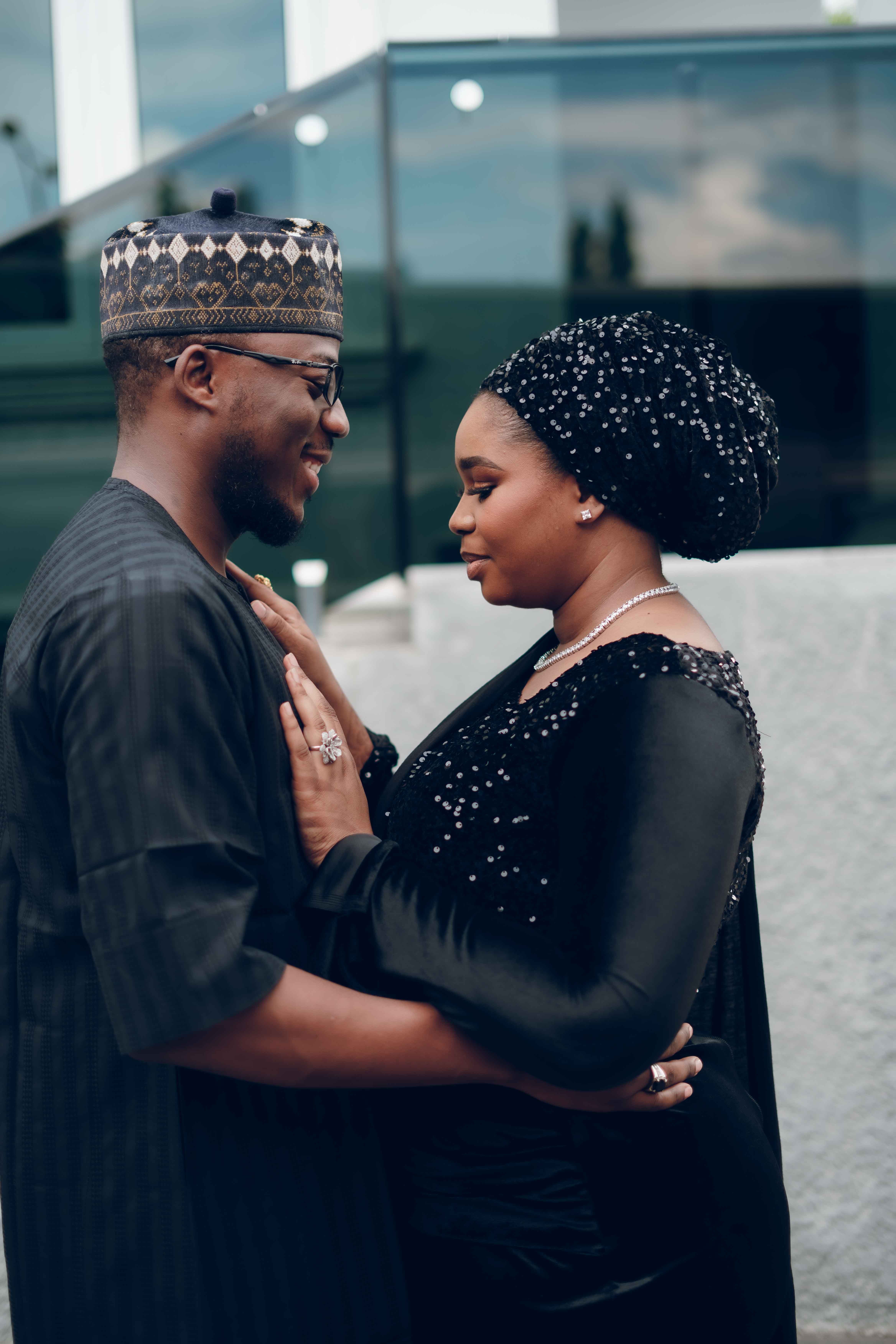 Elegant couple in traditional attire embracing outdoors · Free Stock Photo