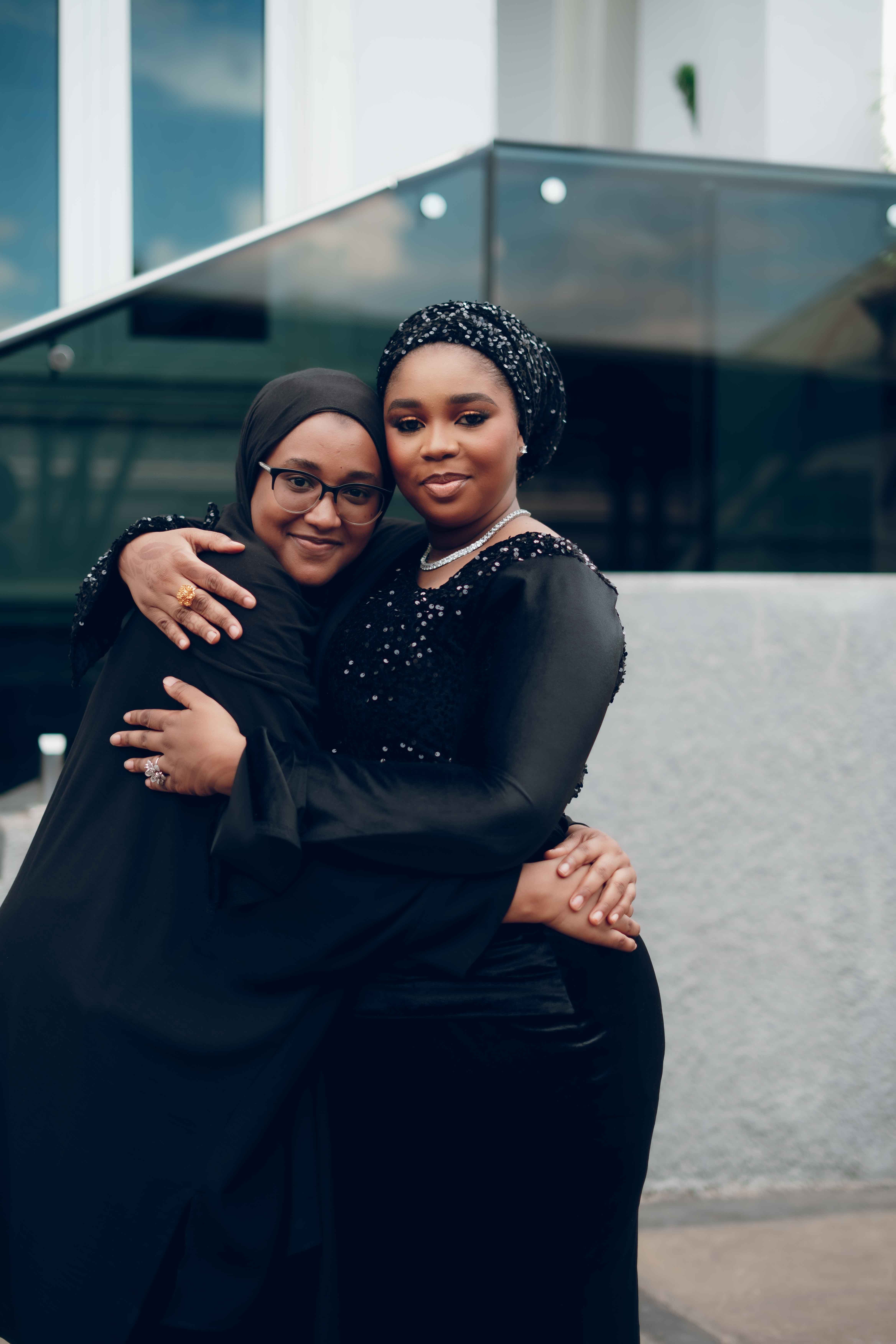 Two Women Embracing Outdoors in Stylish Attire · Free Stock Photo