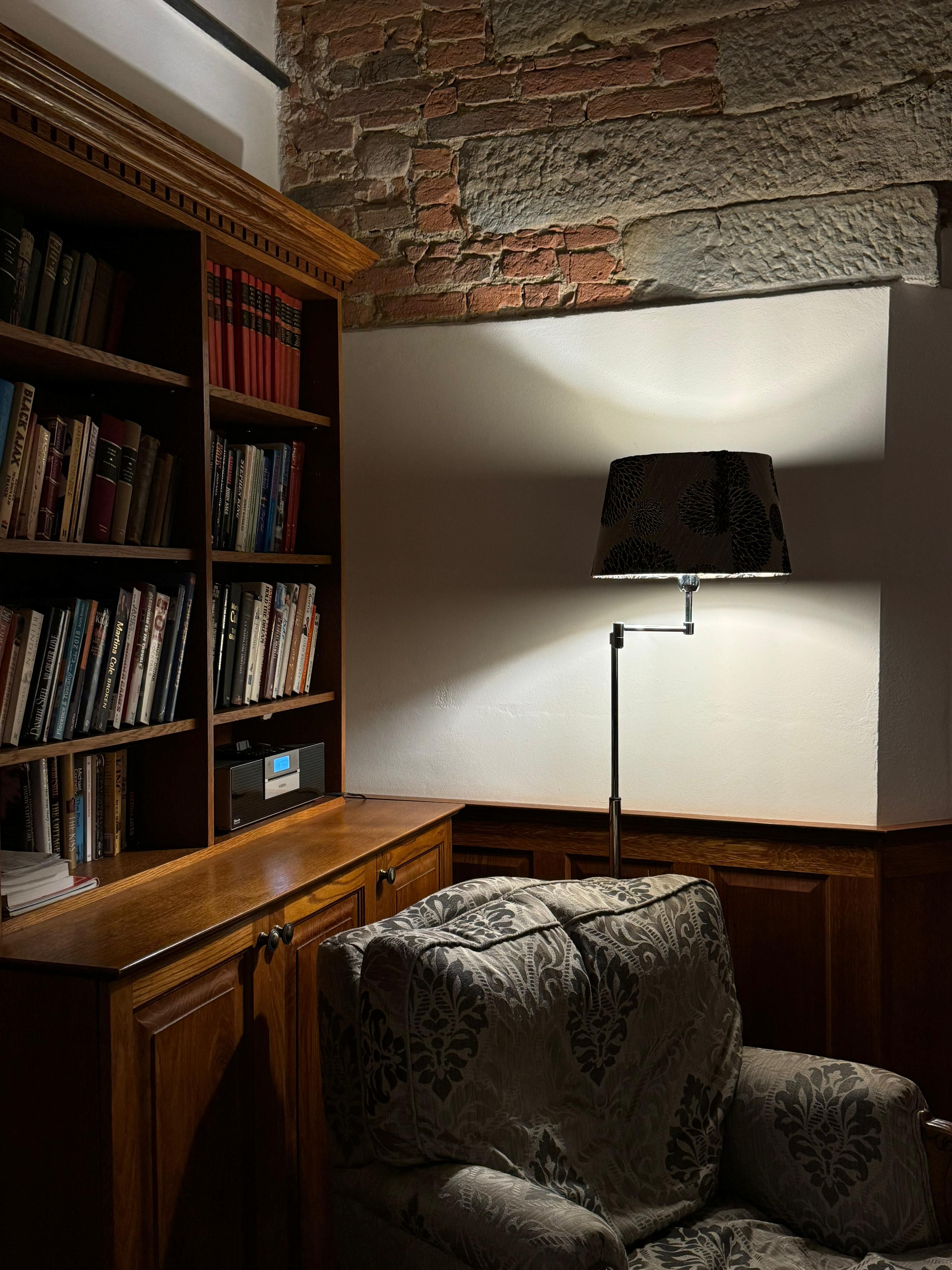A bookshelf with bound legal volumes and a desk lamp