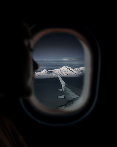 Free Captivating view of snowy mountains through an airplane window, showcasing Armenian scenery. Stock Photo