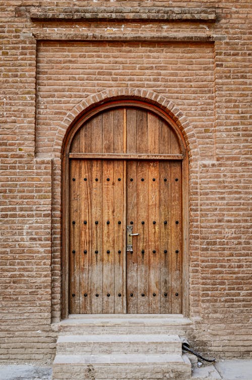 Free Wooden Door Of A Bricked Wall Stock Photo