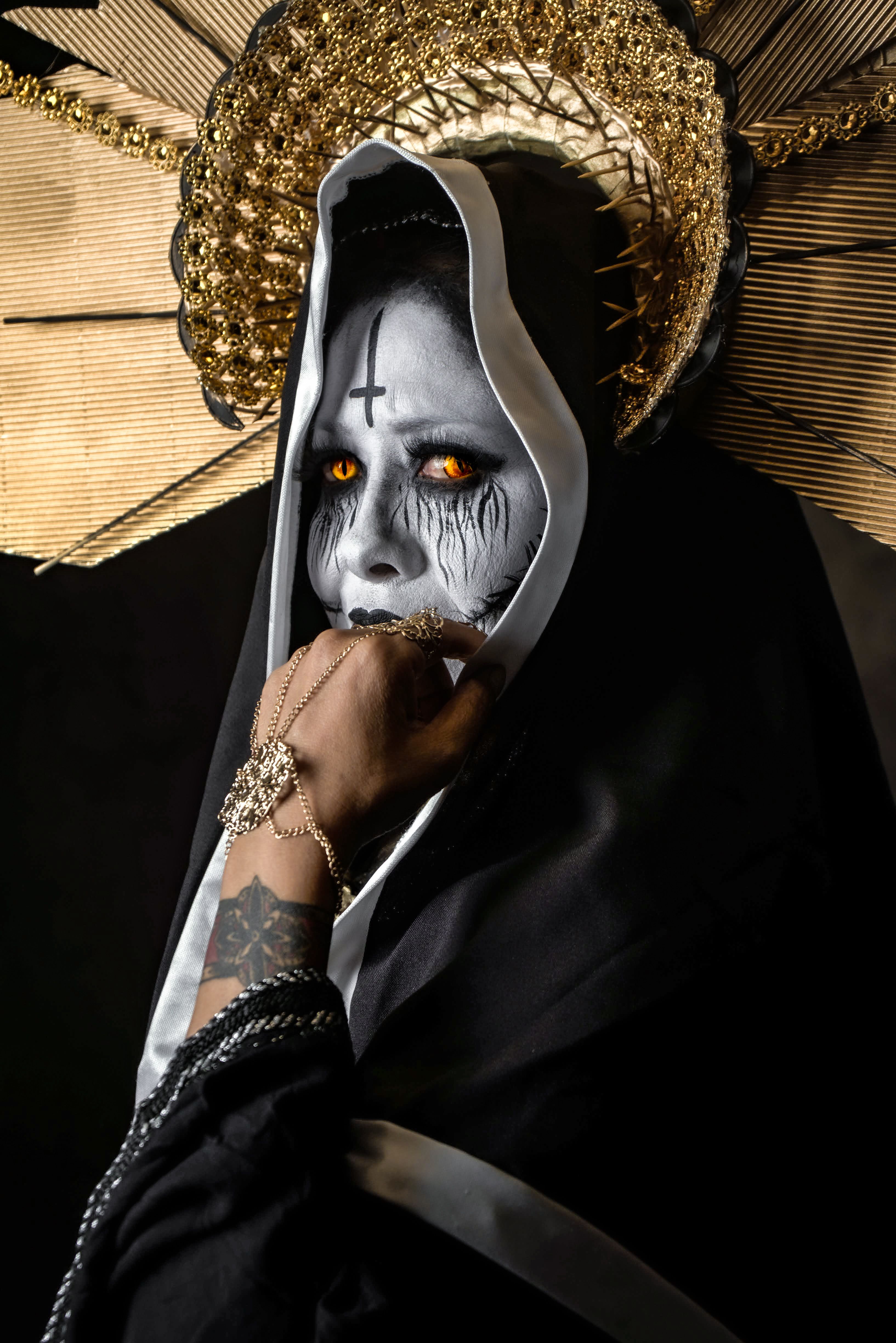 Dark and captivating portrait of a gothic figure with striking orange eyes and ornate headdress