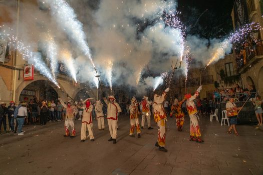 Dramatic night-time correfoc celebration with performers and fireworks in Les Borges Blanques, Cataluña, Spain.
