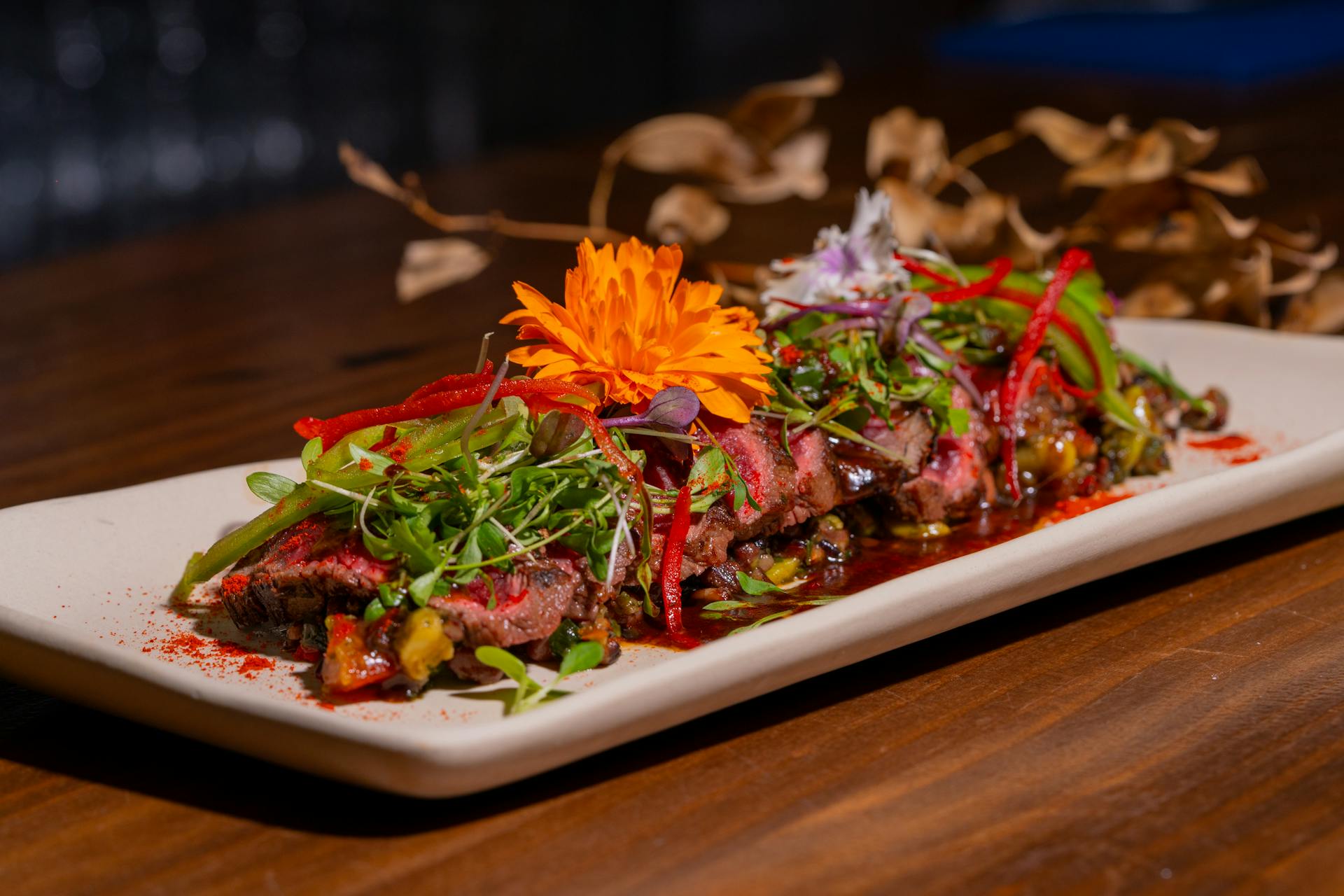 Gourmet Beef Dish Garnished with Edible Flowers