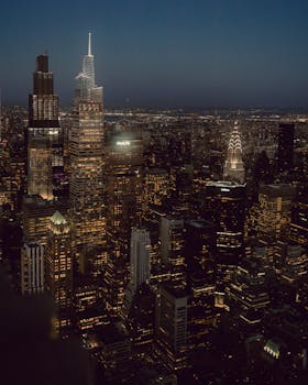 Stunning night view of New York City's skyline featuring iconic skyscrapers and city lights.