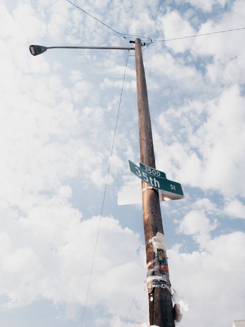 Free A street sign on a lamp post under a bright blue sky in Denver, Colorado. Stock Photo