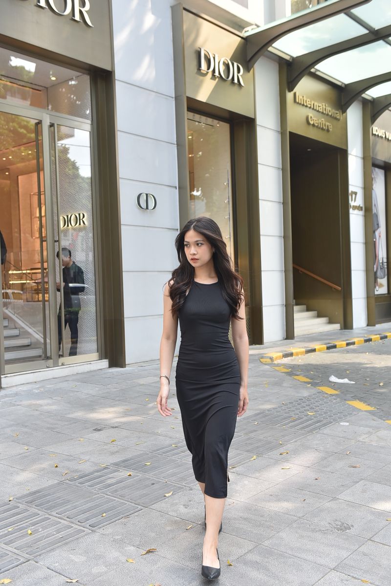 Woman in chic black dress, boutique storefront