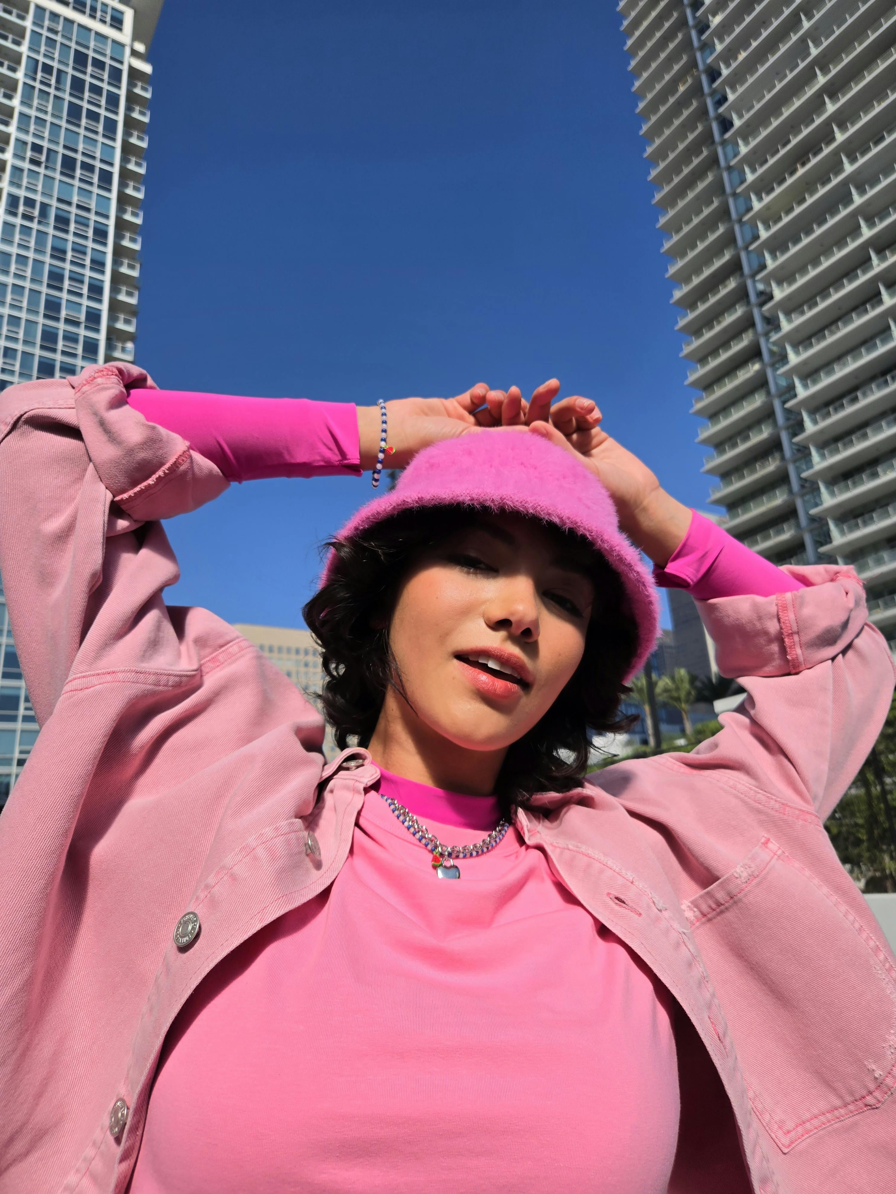 fashionable woman in pink urban setting