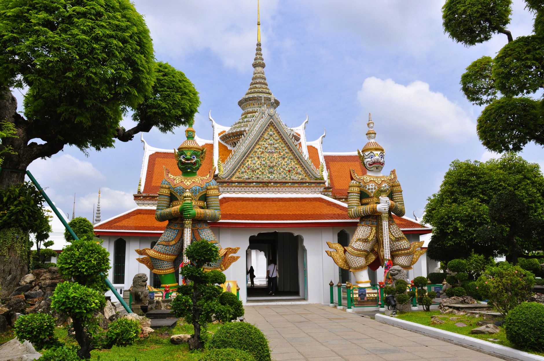 Vibrant giant demon statues at Wat Arun temple, Bangkok, Thailand.