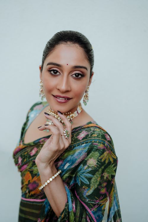 Free Portrait of an Indian woman in traditional attire, showcasing elegant jewelry and a colorful saree. Stock Photo