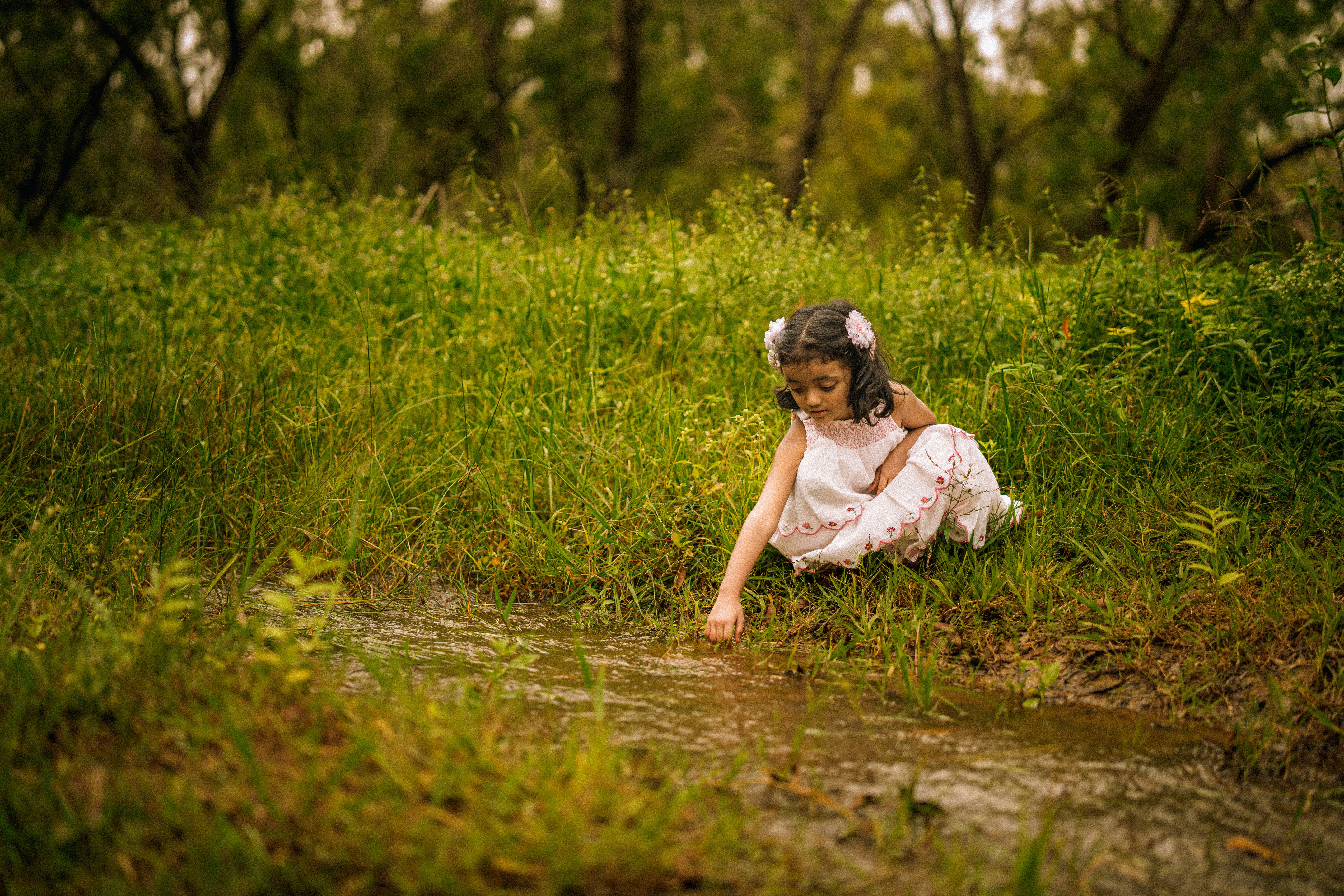 Little Girl Exploring Nature by a Stream in Tumakuru · Free Stock Photo