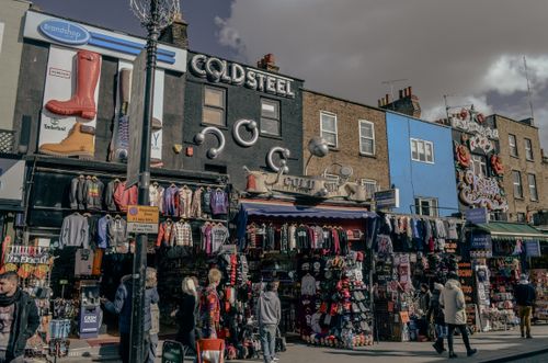 Free A vibrant street view of Camden Market in London showcasing quirky fashion shops and bustling activity. Stock Photo