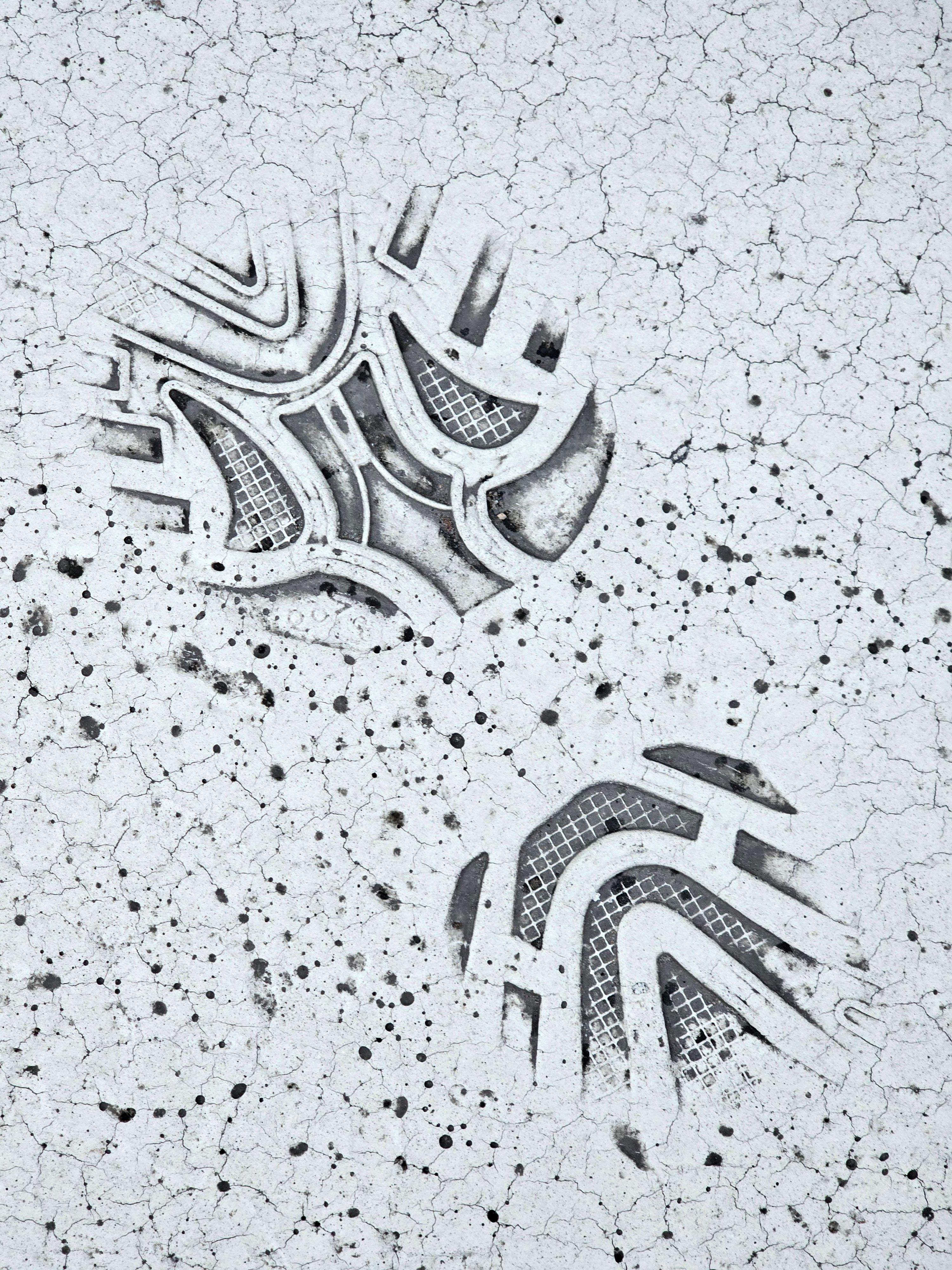 Detailed footprints on a cracked surface, captured in Lappeenranta, Finland.