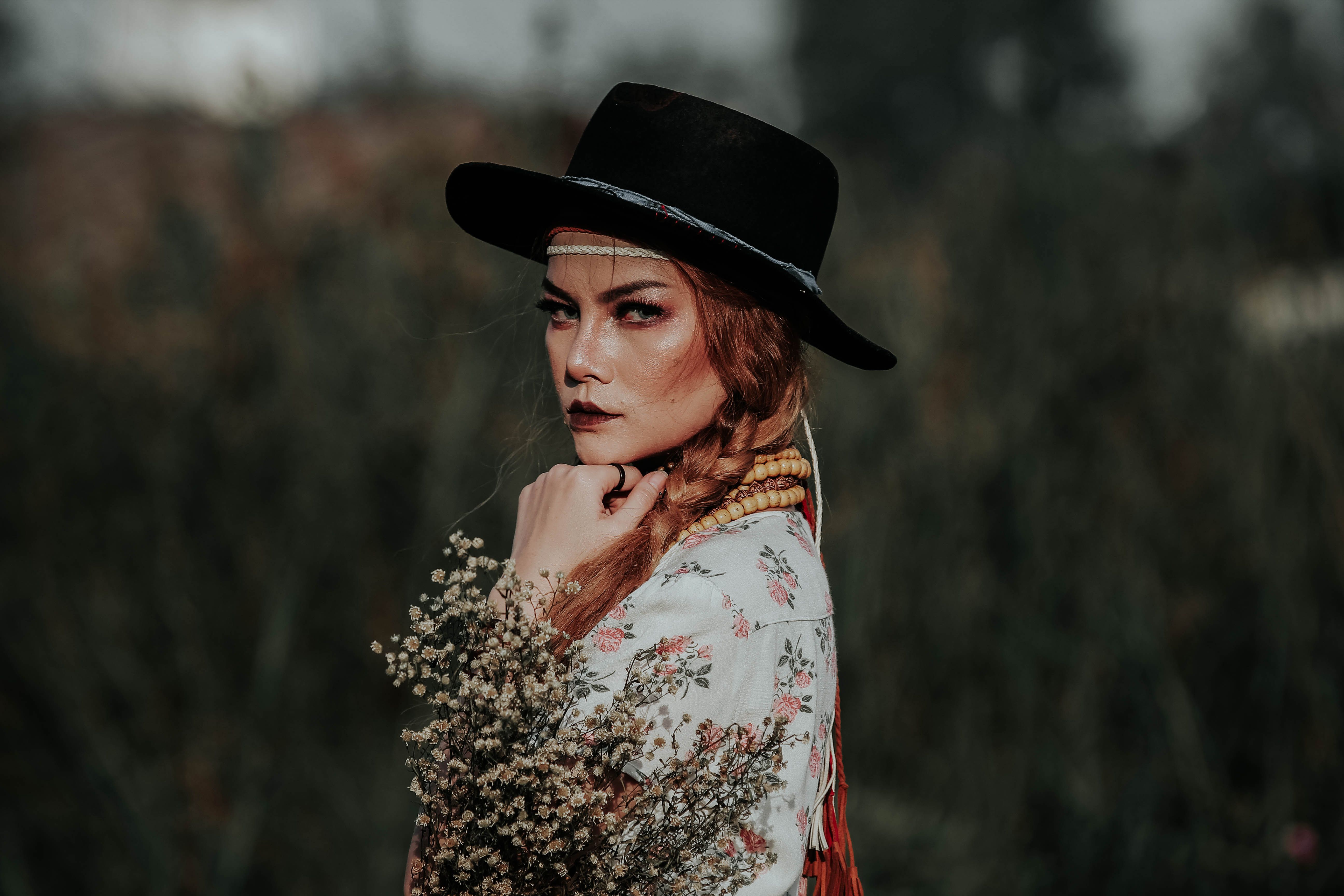 Portrait of Woman in Hat with Floral Bouquets · Free Stock Photo