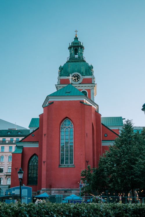 Free Beautiful view of St. James's Church with its striking red façade and green dome in Stockholm. Stock Photo