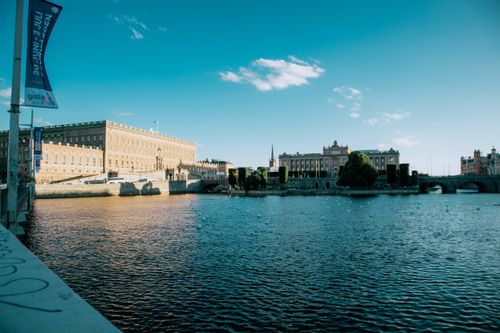 Free Panoramic view of the Stockholm Royal Palace by the waterfront in daylight. Stock Photo