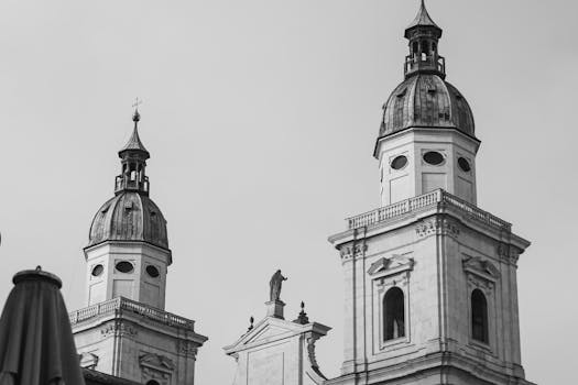 Black and white image showcasing the twin towers of Salzburg Cathedral's Baroque architecture.