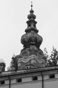 Black and white image of a historic church tower in Salzburg, Austria.