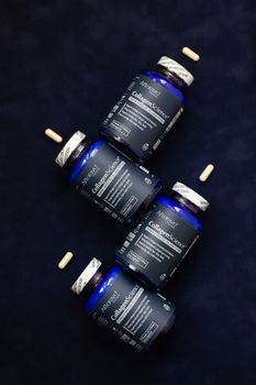 AltNeve collagen supplements arranged artfully on a navy blue surface with capsules.