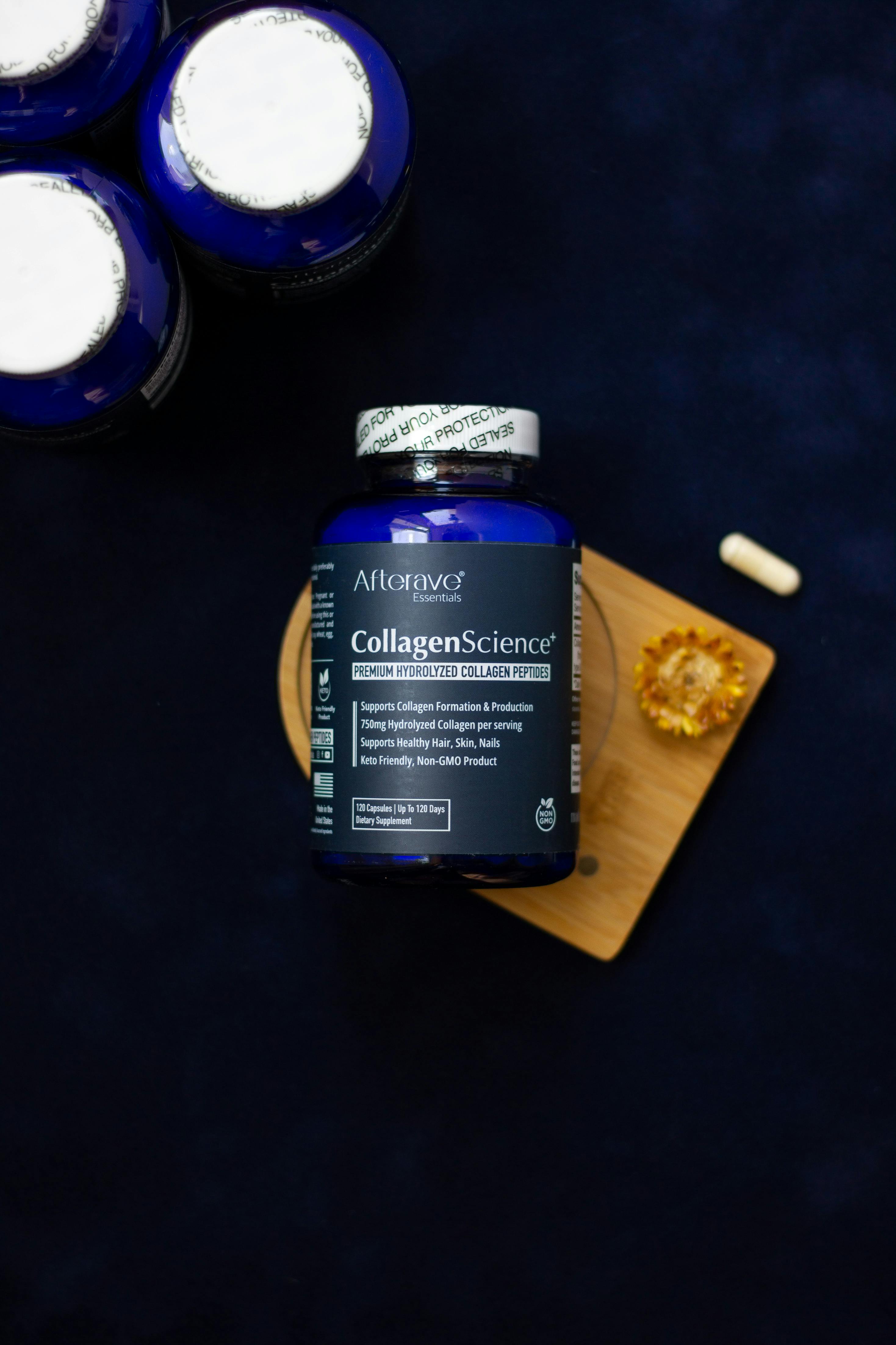 Premium collagen supplement bottle with pills on a wooden board.