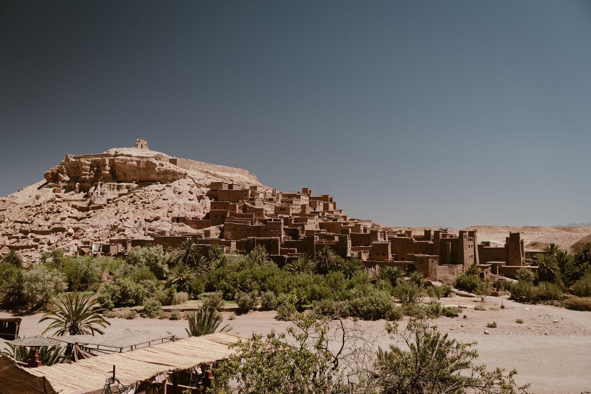 Kasbah of Ait Ben Haddou framed by palm trees, Morocco
