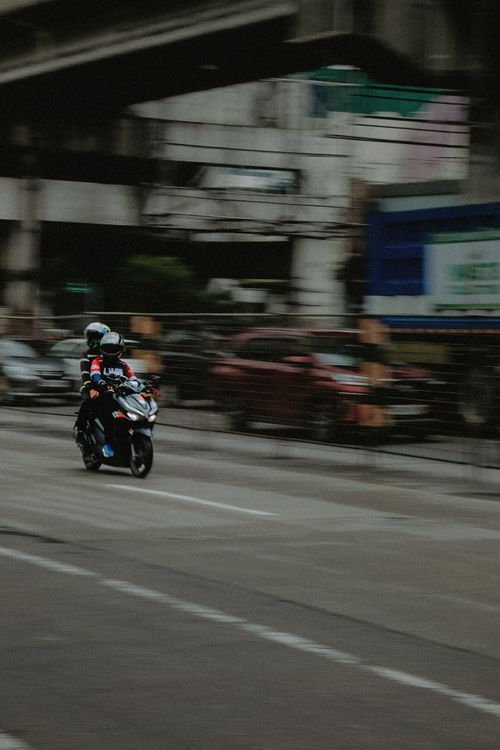 Free Dynamic capture of a motorcycle on a busy street in Quezon City, Metro Manila. Stock Photo