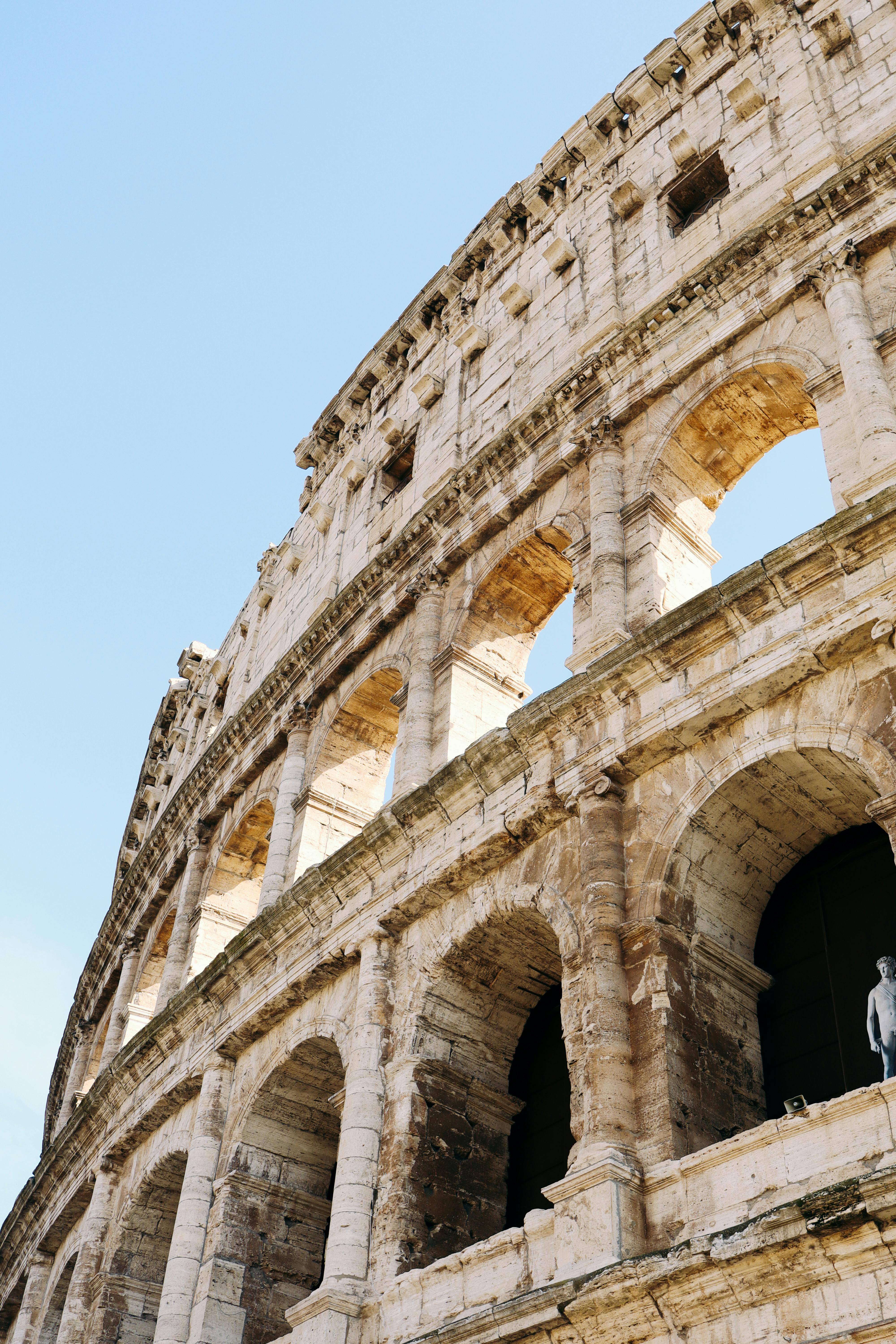 Free A close-up view of the iconic Colosseum in Rome, showcasing its ancient architecture. Stock Photo