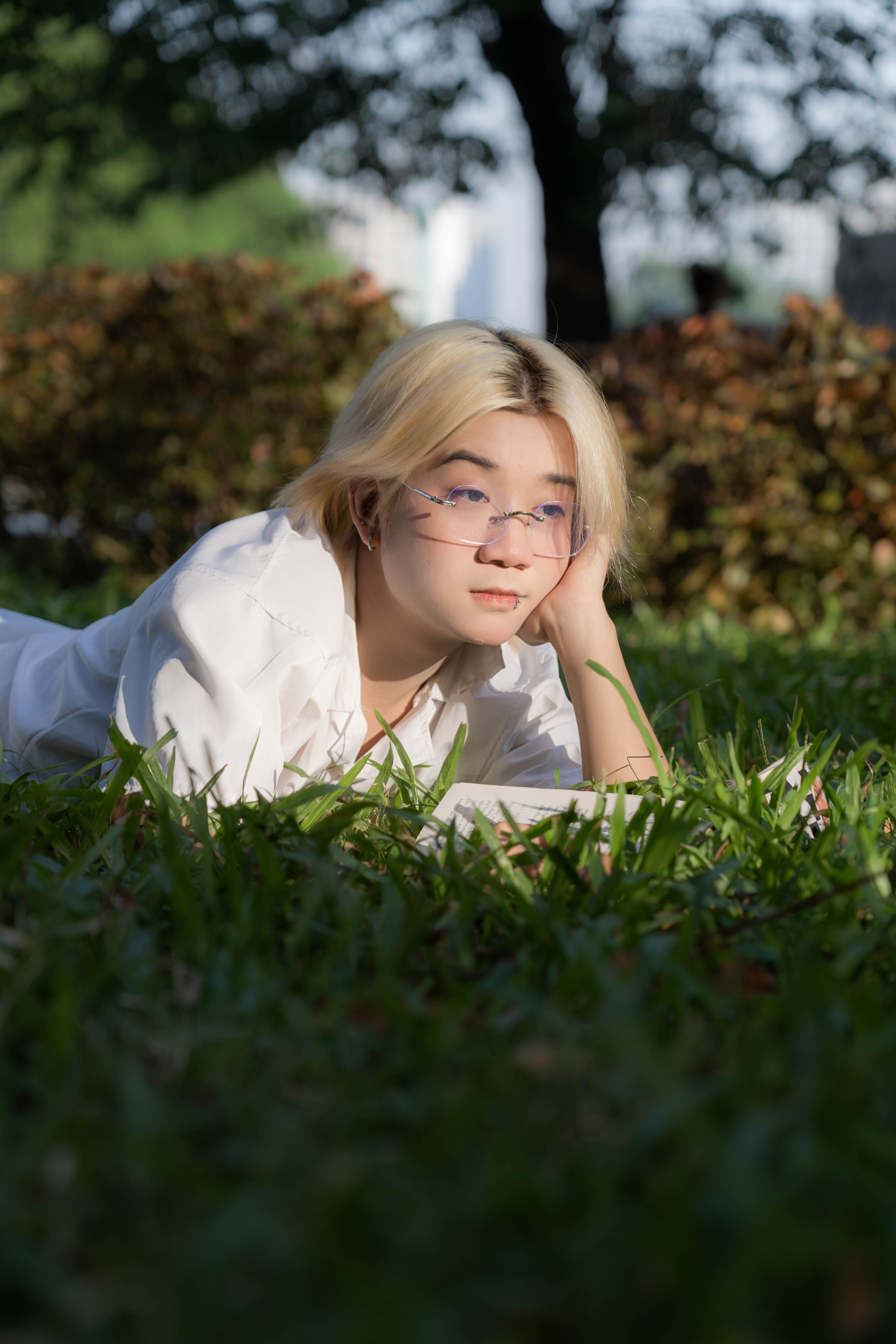 Young Woman Relaxing on Grass in Hanoi Park · Free Stock Photo