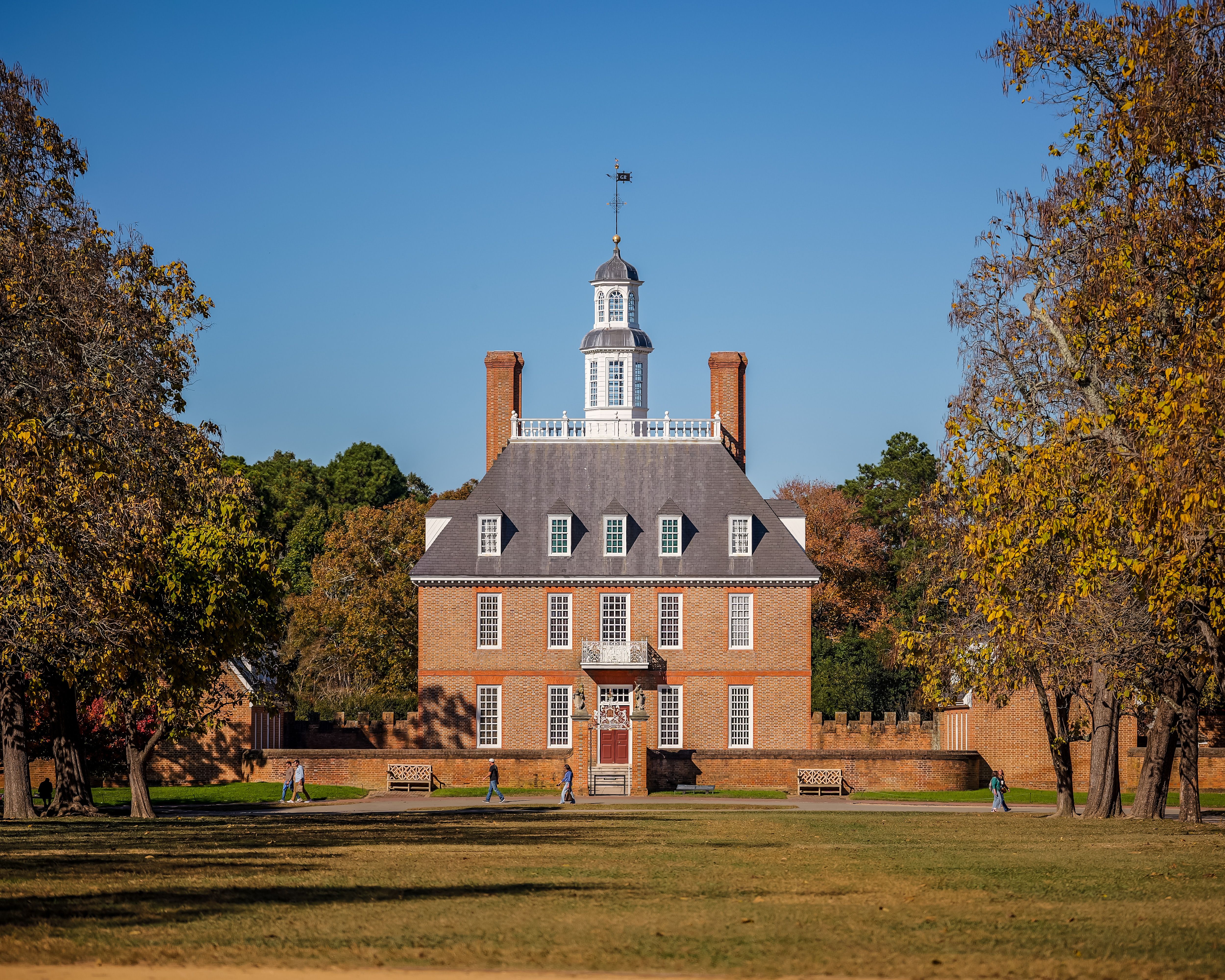 Historic Governor's Palace in Colonial Williamsburg surrounded by autumn foliage.