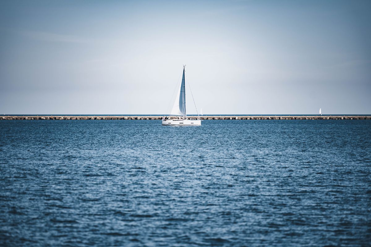 Boats along the calm shoreline of Spring Lake, Michigan