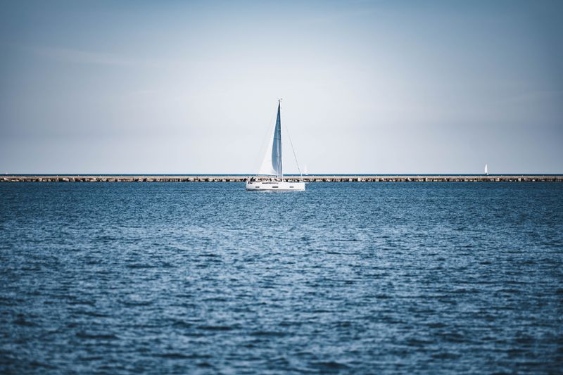Boats along the calm shoreline of Spring Lake, Michigan