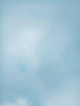 An expansive view of a clear blue sky with gentle wispy clouds creating a peaceful atmosphere.