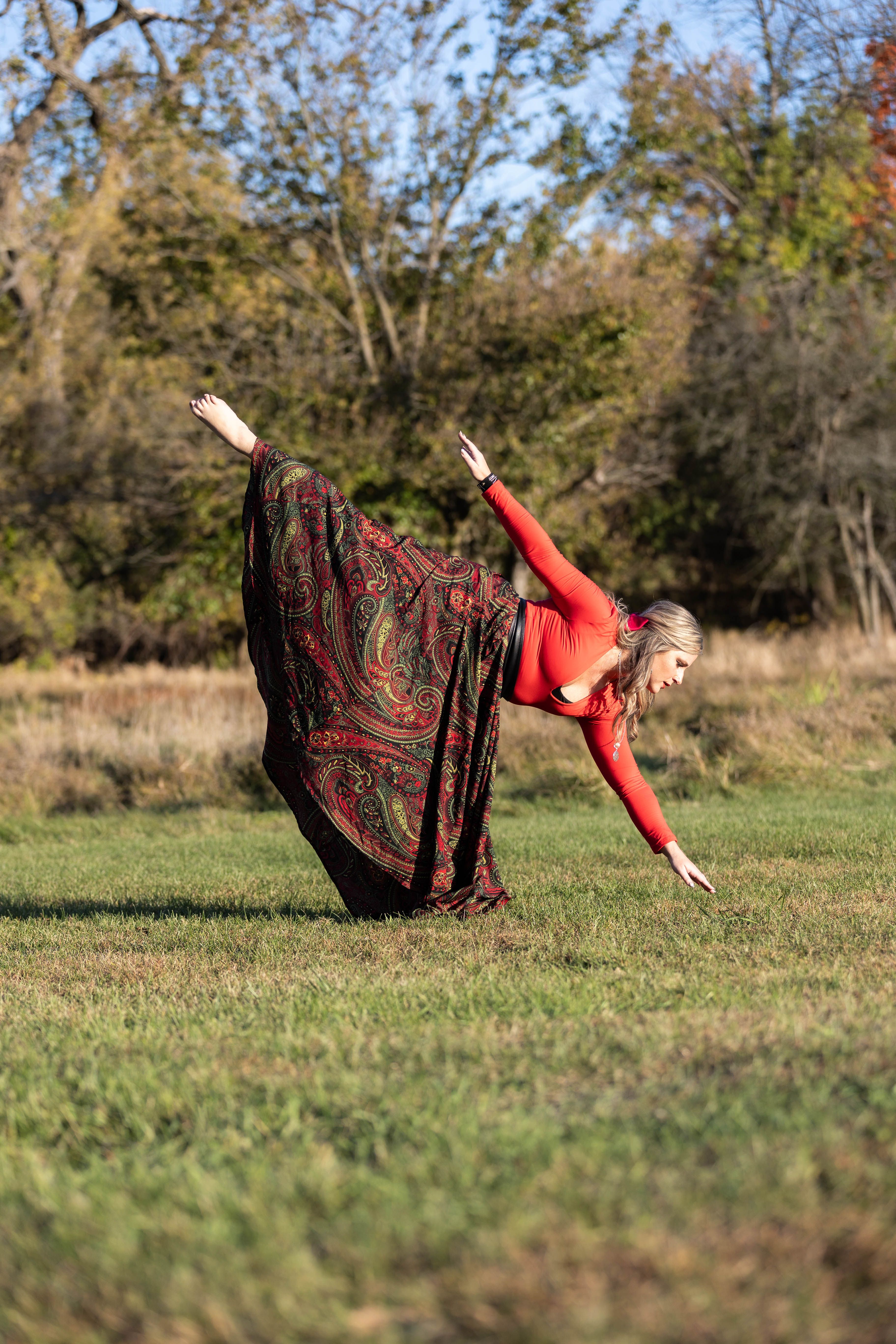 Woman in Vibrant Outfit Balancing Outdoors · Free Stock Photo