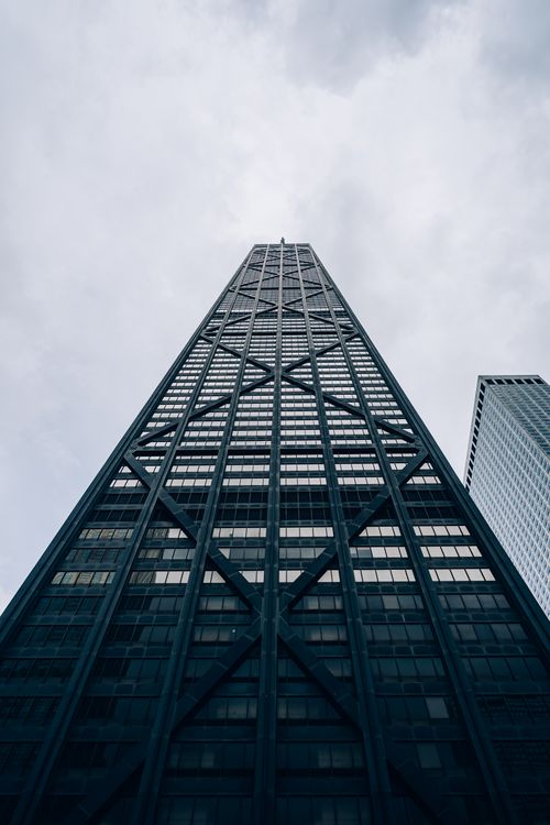 Free Dramatic low angle shot of the John Hancock Center skyscraper in Chicago, capturing its unique architecture against the sky. Stock Photo