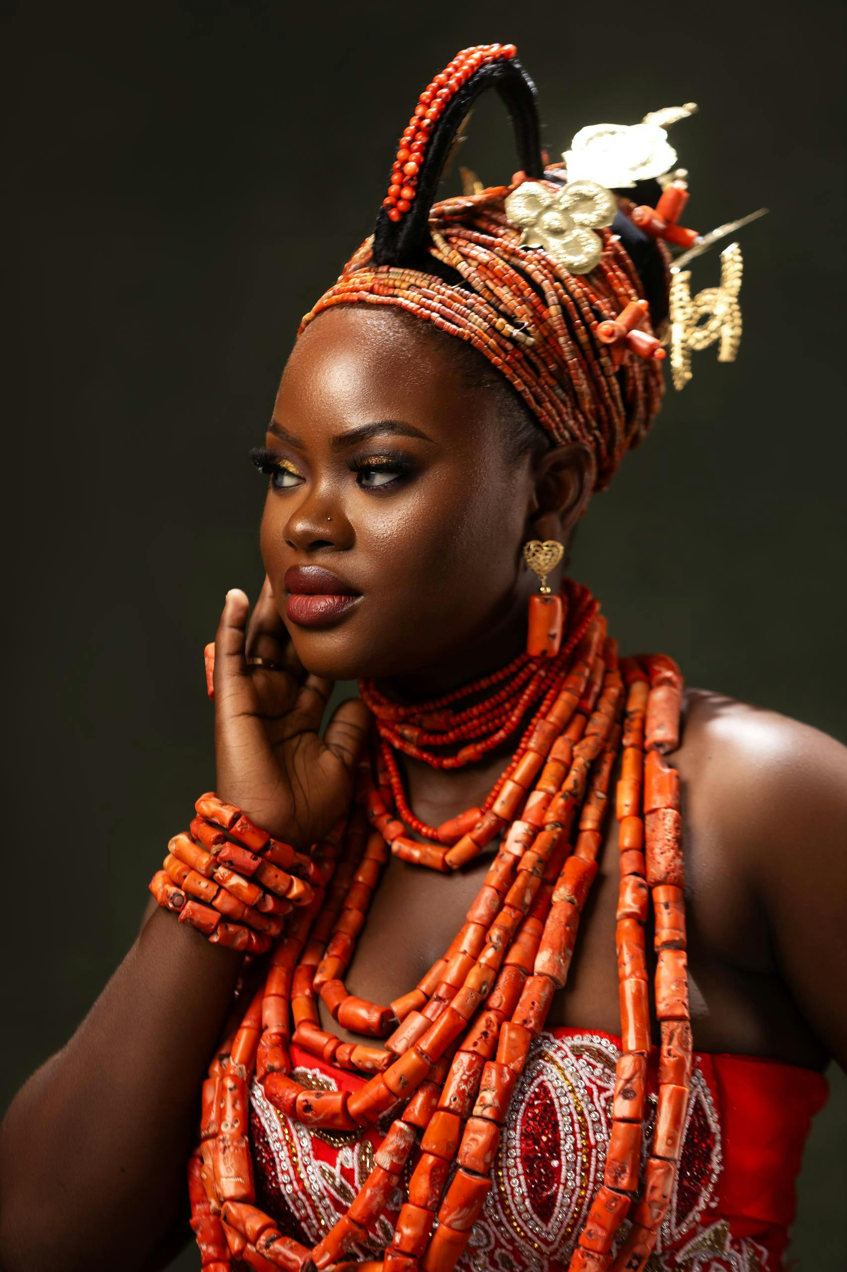 Free Beautiful portrait of a Nigerian woman in elaborate traditional attire with vibrant coral beads, showcasing cultural elegance. Stock Photo