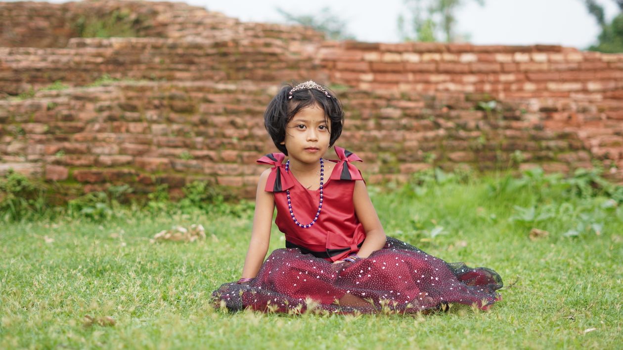 Charming Young Girl in Traditional Dress Outdoors · Free Stock Photo