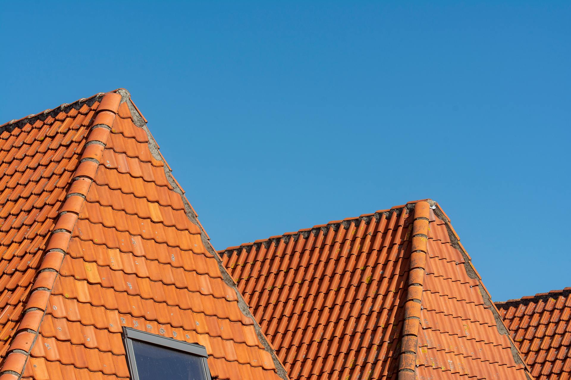 Red Roof Tiles Against Clear Blue Sky