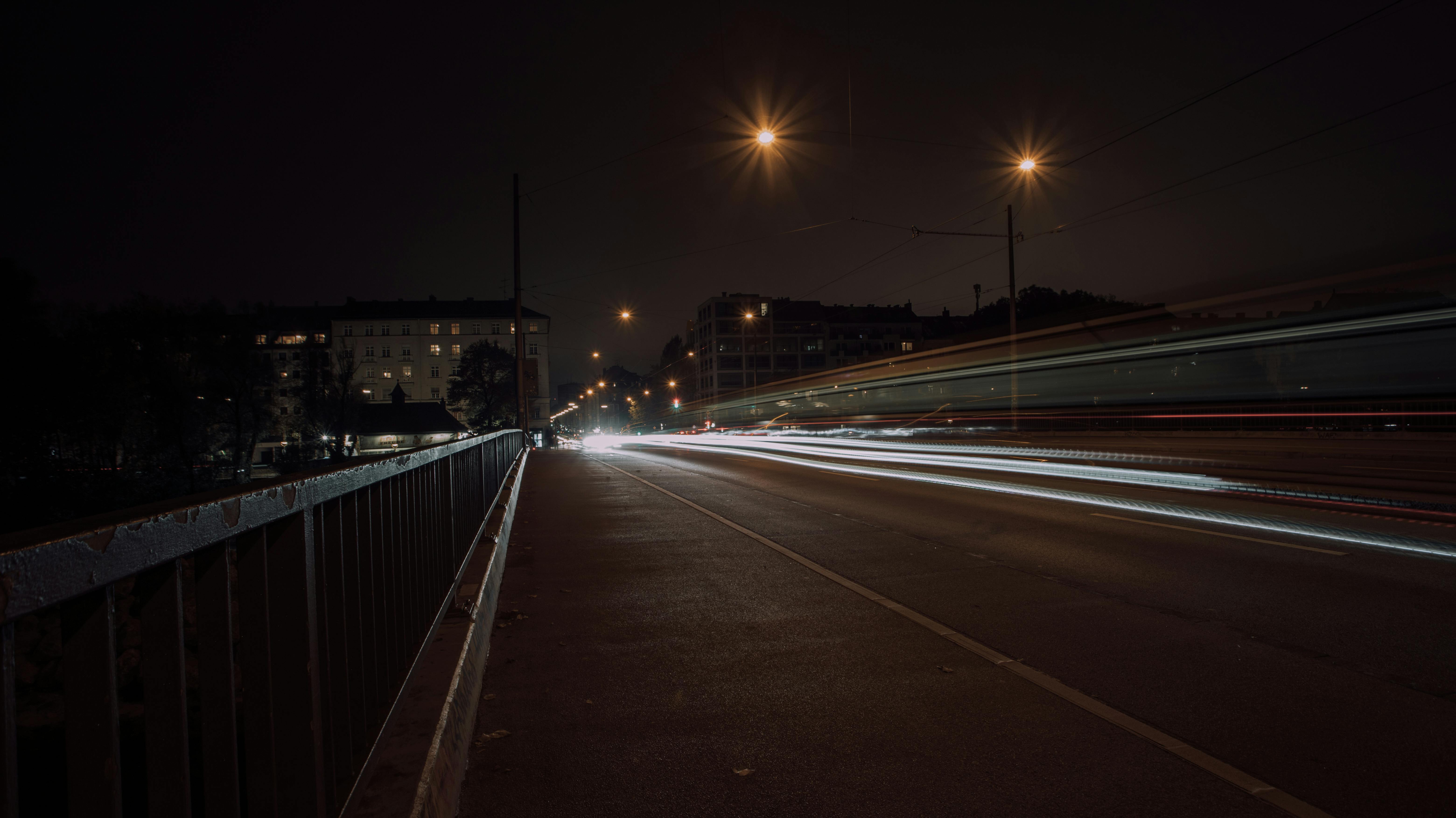 Long exposure of moving traffic in Munich, highlighting vivid light trails against a night sky.