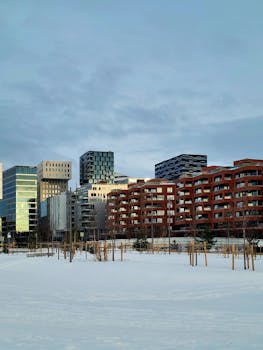 A striking view of Oslo's modern architecture set amidst a serene winter landscape.