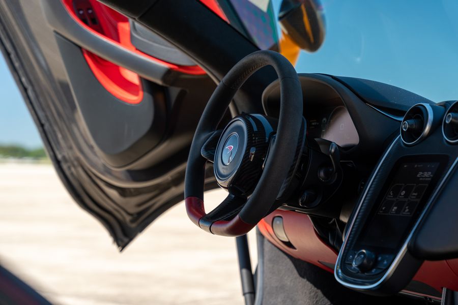 McLaren steering wheel and cockpit where faster gear changes are felt