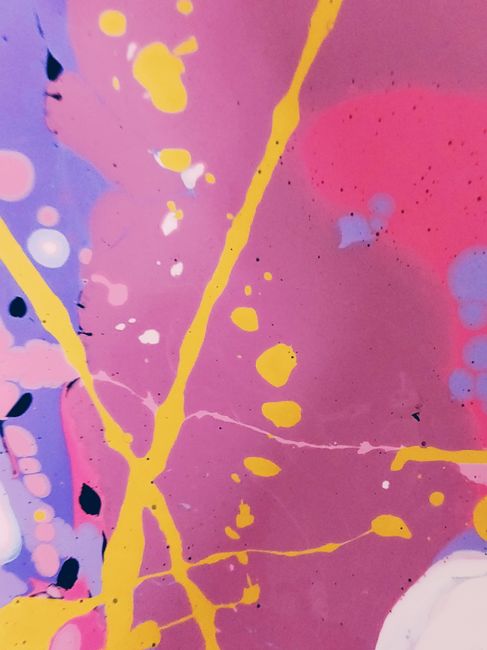 Colorful abstract painting featuring bold splashes of yellow on a purple and pink background.