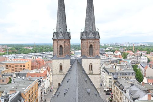 Free Aerial photo capturing the twin spires of Hallstatt Church overlooking the rooftops of a historic German city. Stock Photo