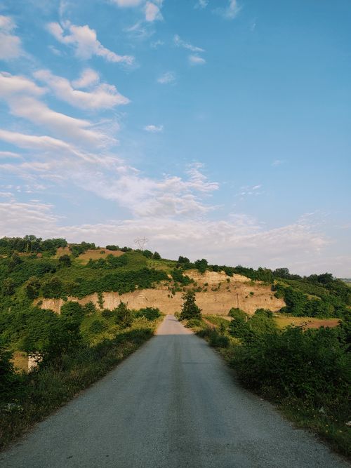 Free Serene road through lush hills under a bright blue sky in Samsun, Turkey. Stock Photo