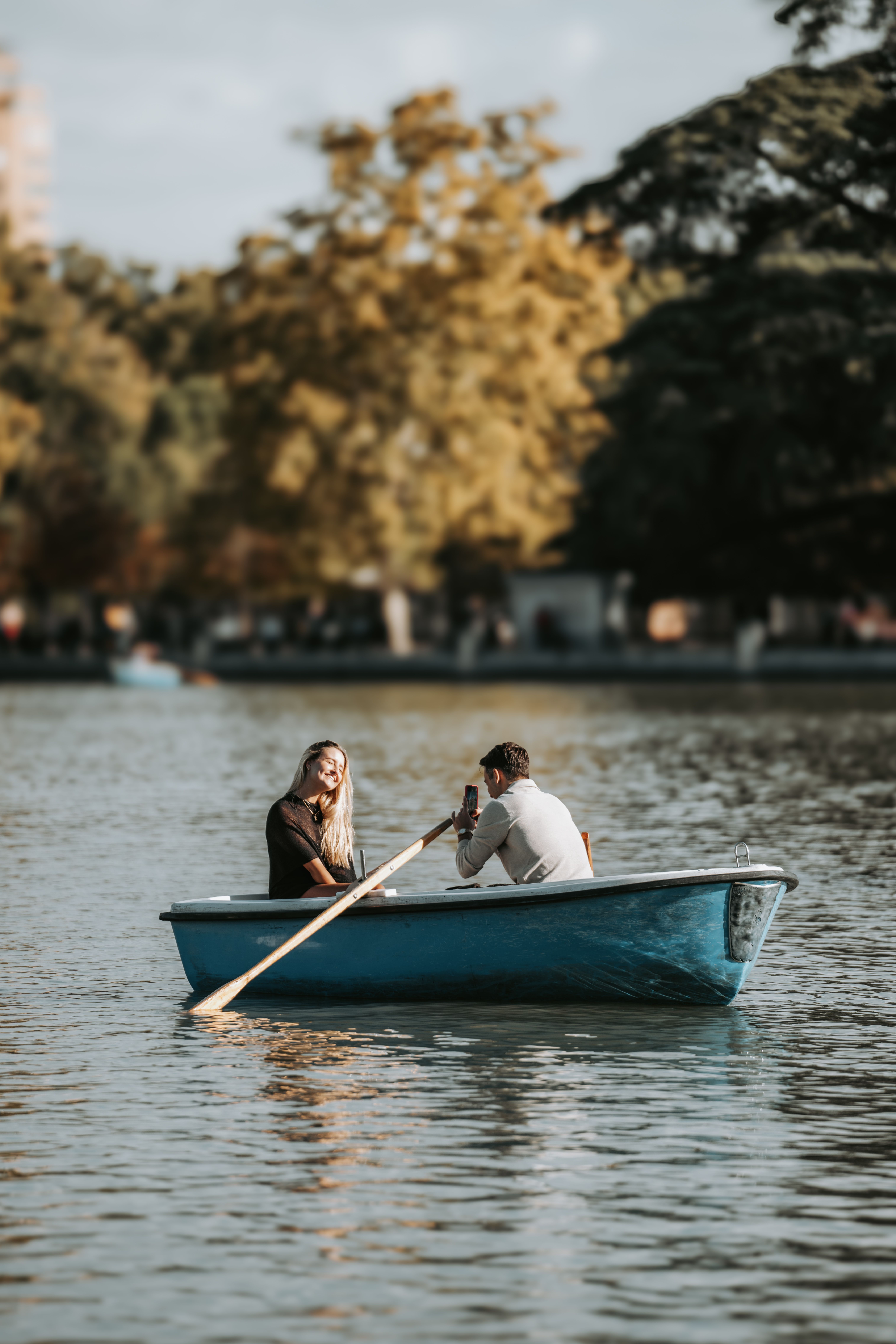 Couple Enjoying a Serene Boat Ride on Lake · Free Stock Photo