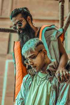 Two stylish young men in edgy streetwear and sunglasses, showcasing modern urban fashion sense.
