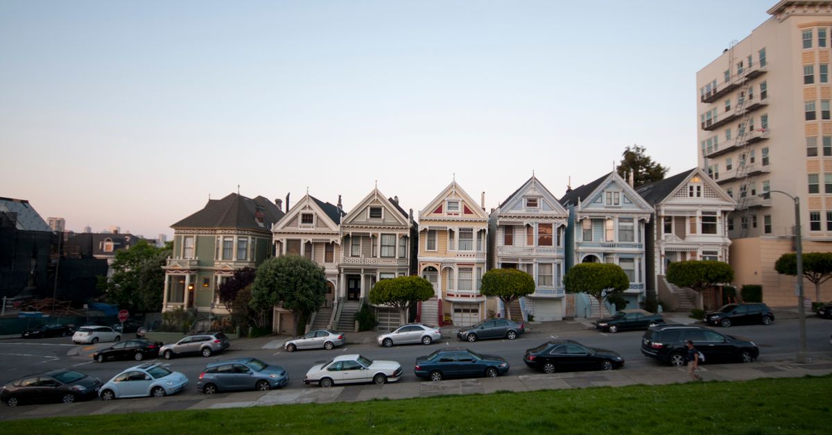 A row of the famous Painted Ladies houses in San Francisco, captured at dusk.